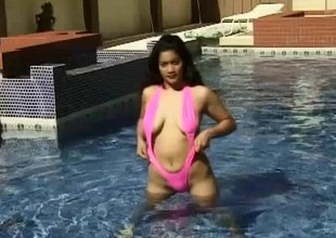 Naughty girl gets naked in the pool together relative to plays relative to the brush muff